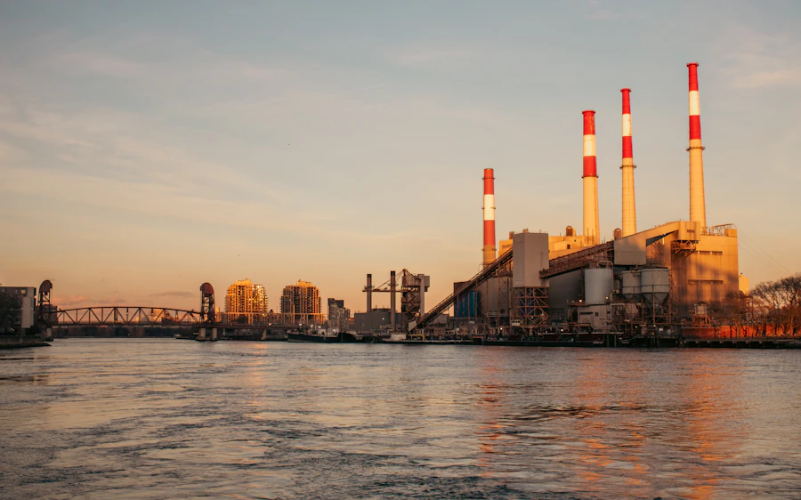 Gas power plant beside water at sunset
