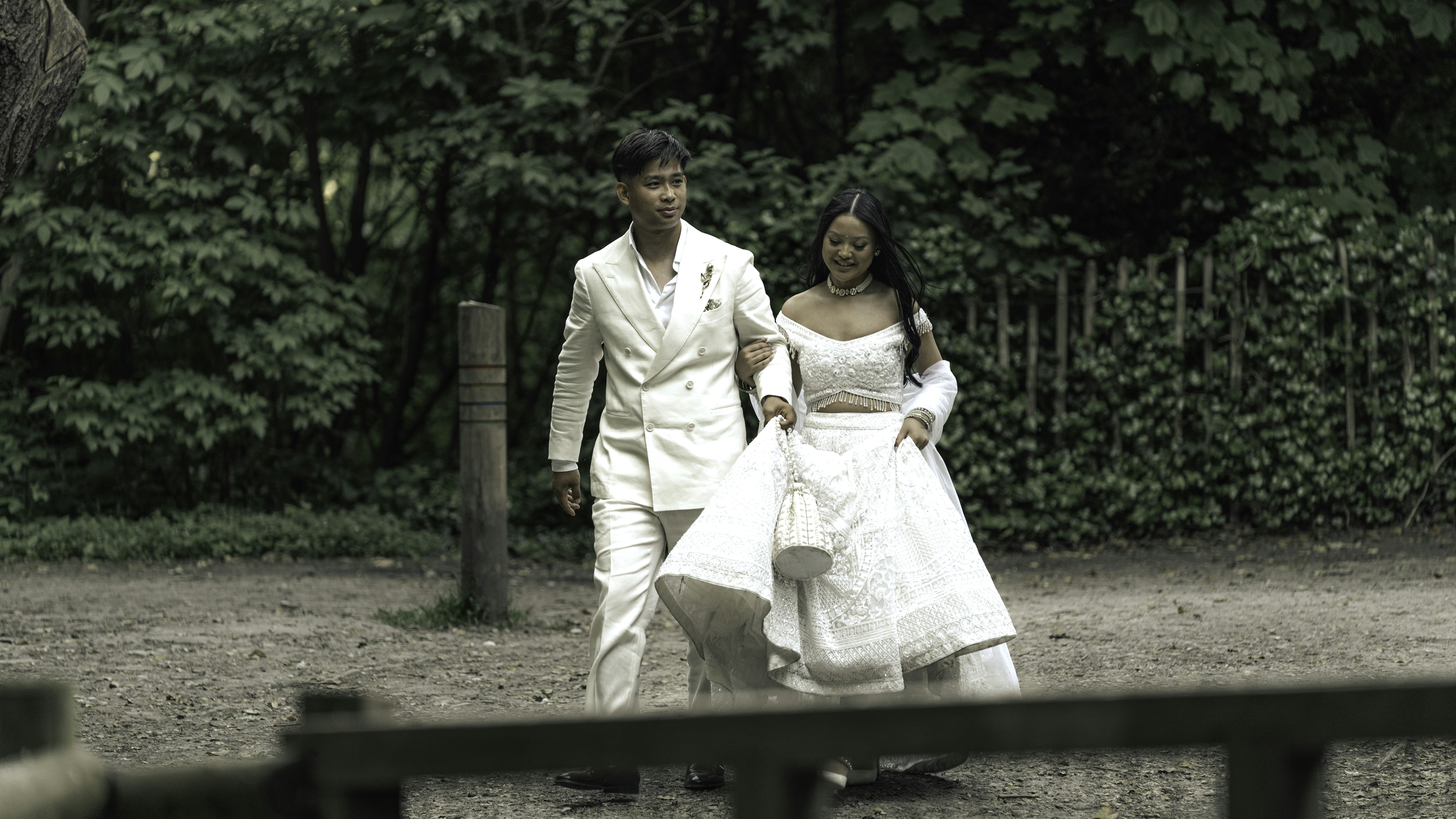 A groom and bride walk together outside