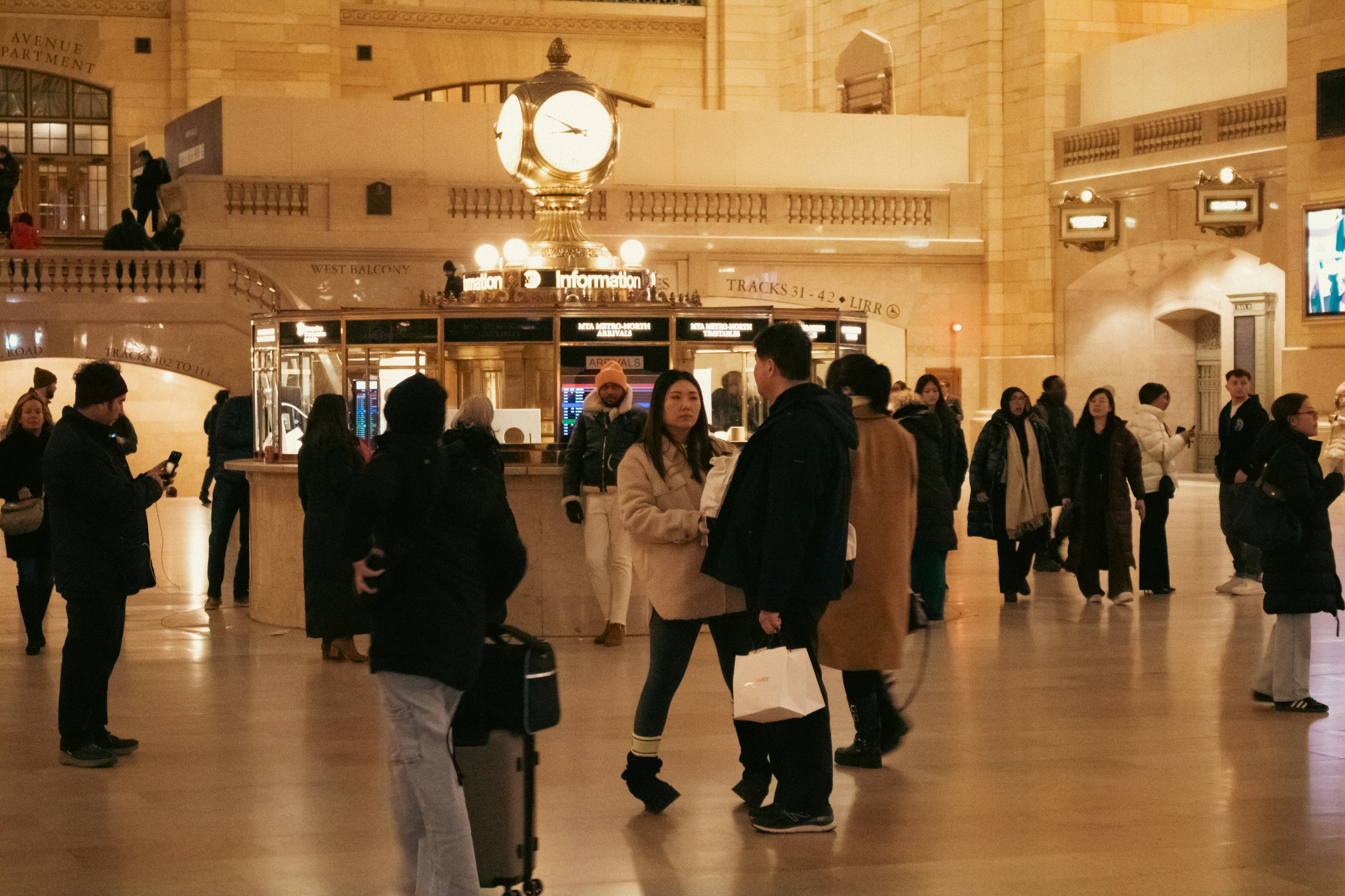 People are in a bustling train station.