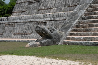 Beyond Chichen Itza - Hidden Mayan Ruins in Mexico The mayan pyramid shows a serpent head carving.
