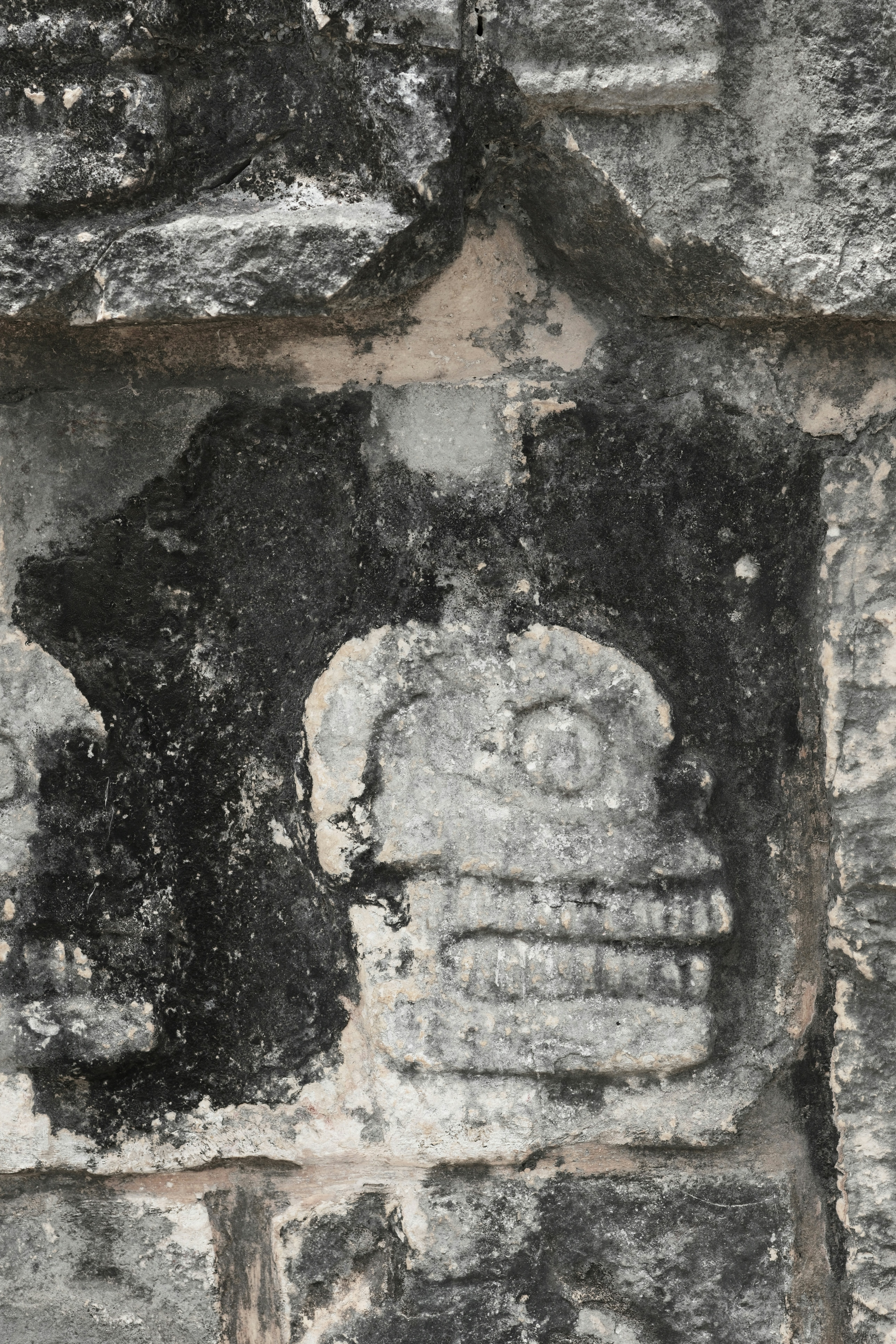 Skull carving on ancient stone.