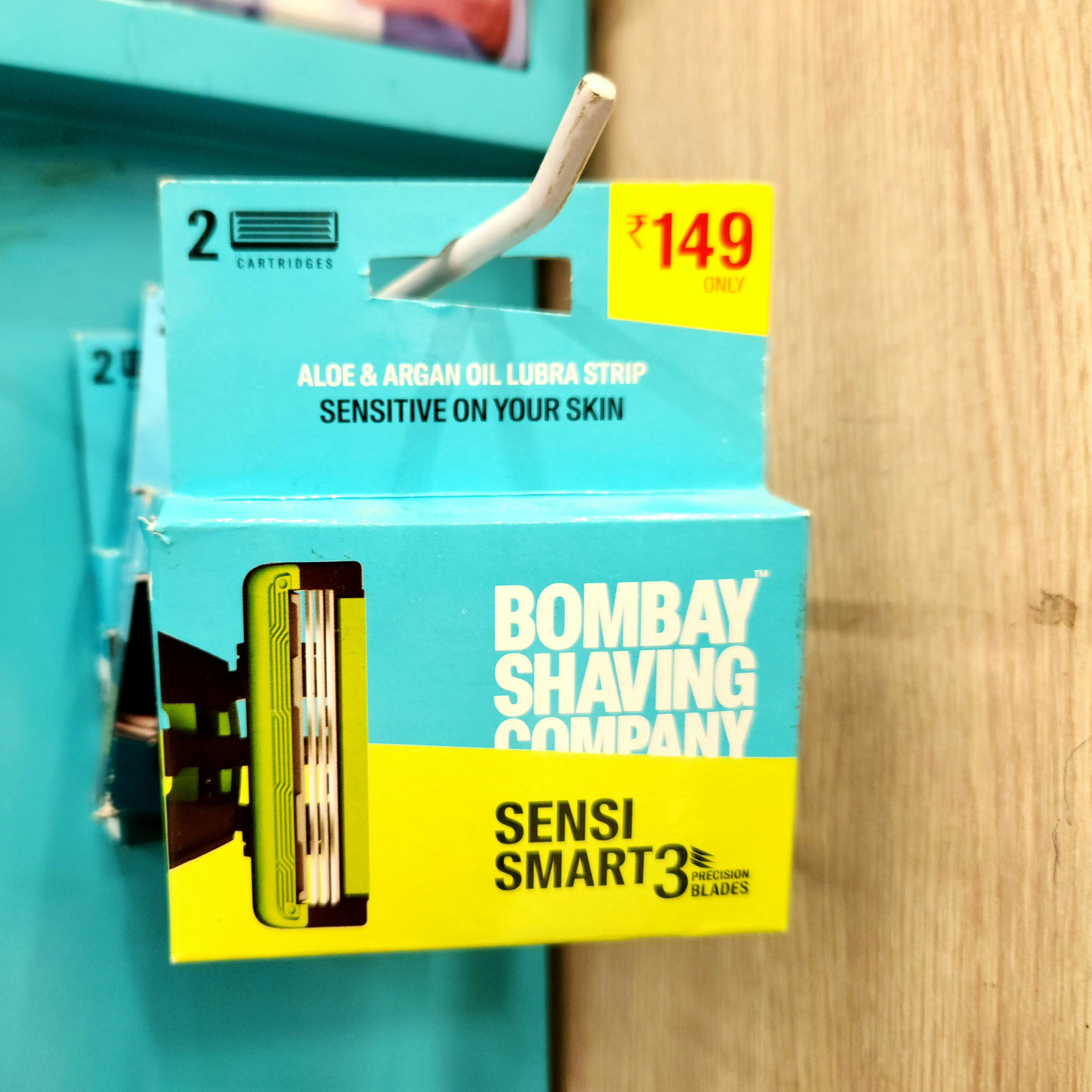 Shaving razors are displayed on a shelf.