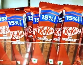 Kit kat chocolate bars are displayed for sale.