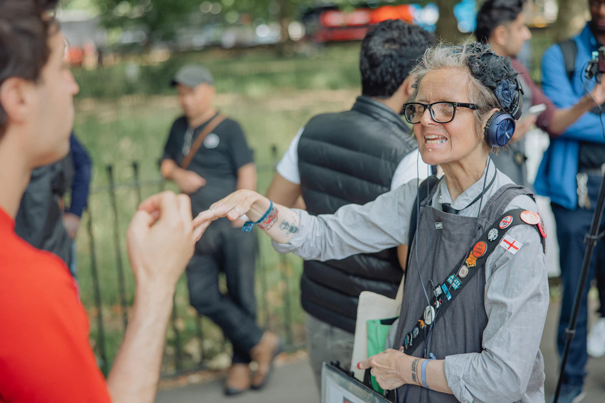 A friendly volunteer communicating warmly using gestures with a member of the community