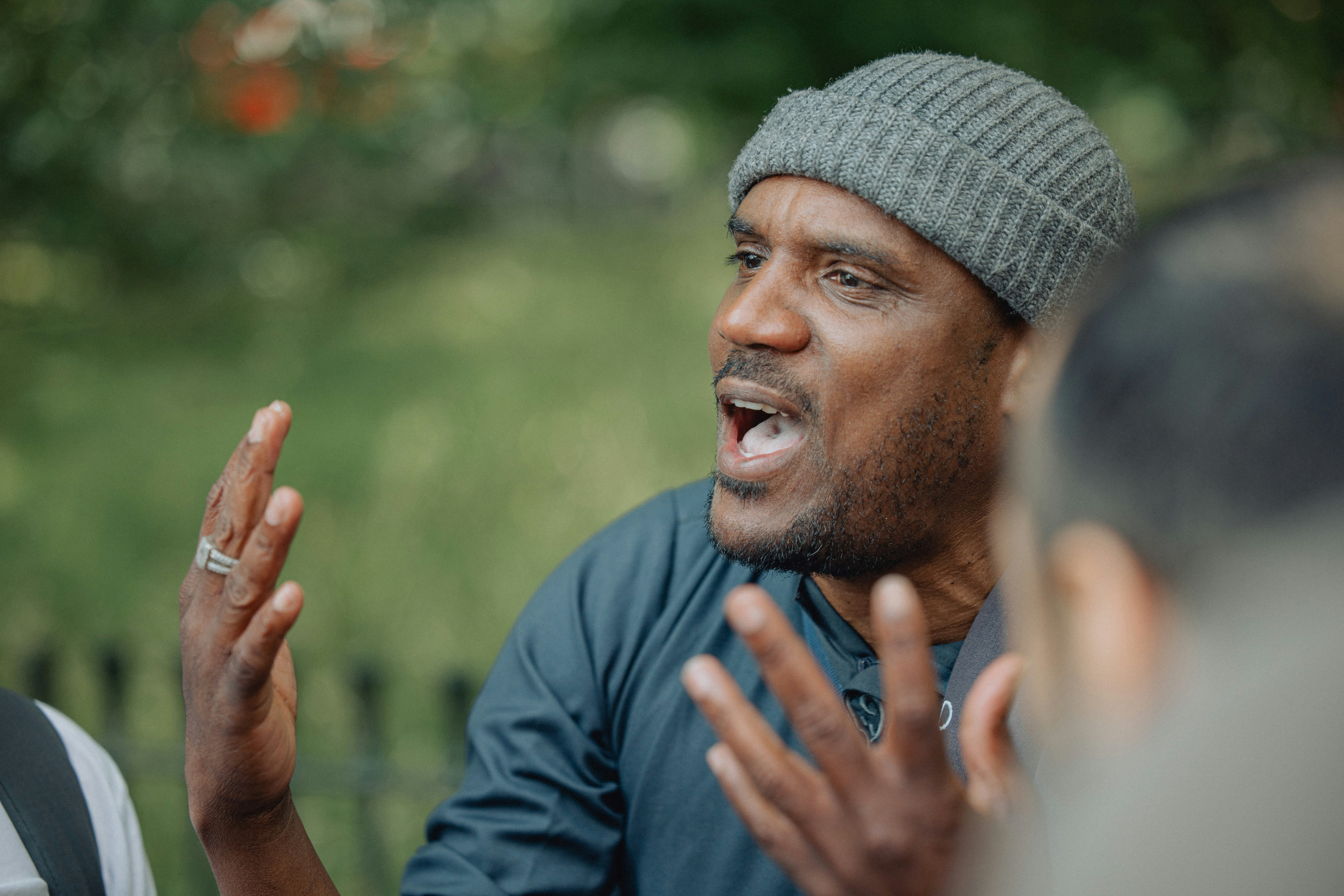 A man is talking passionately to others.
