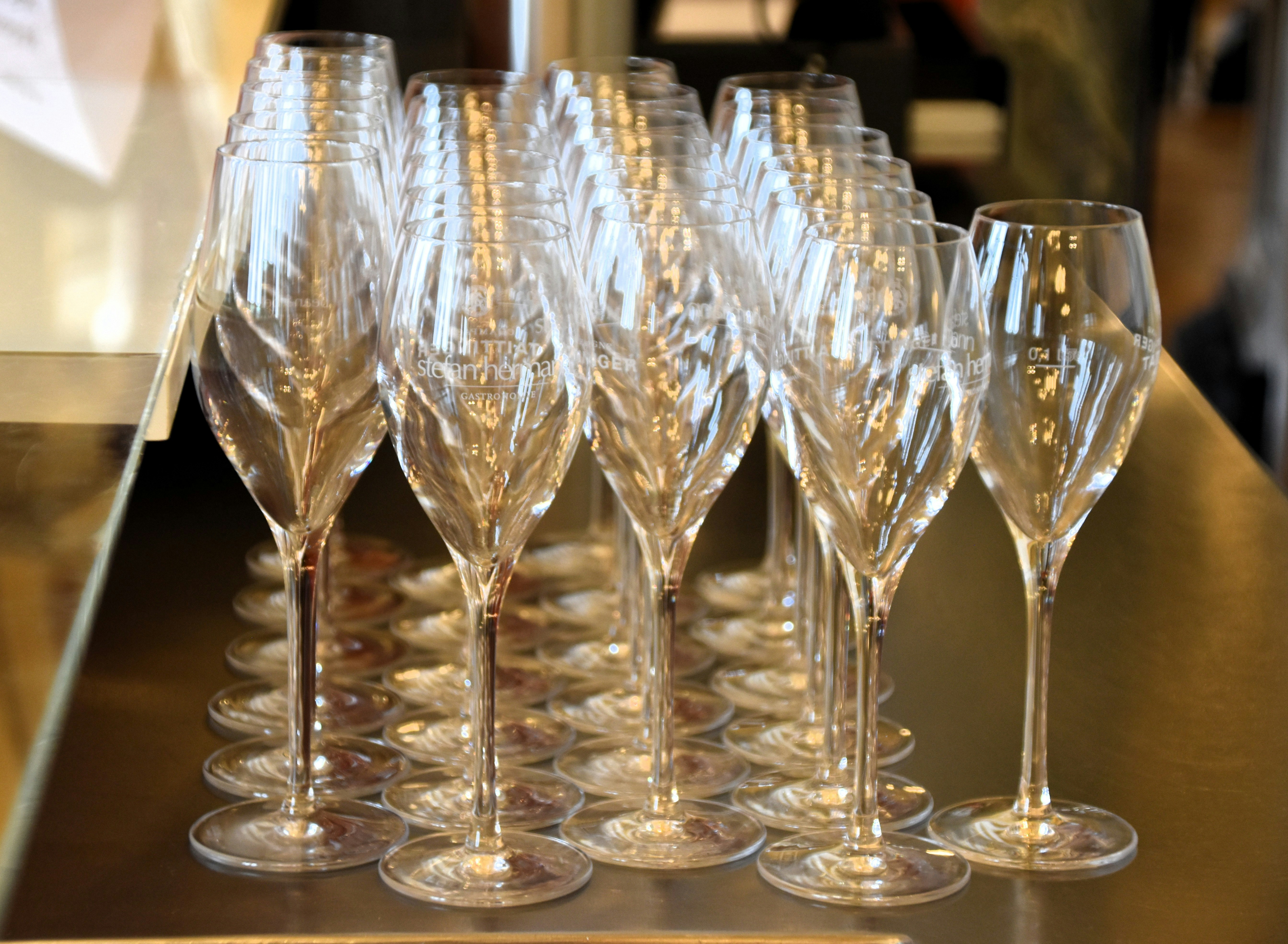 Champagne flutes are neatly arranged in a row.