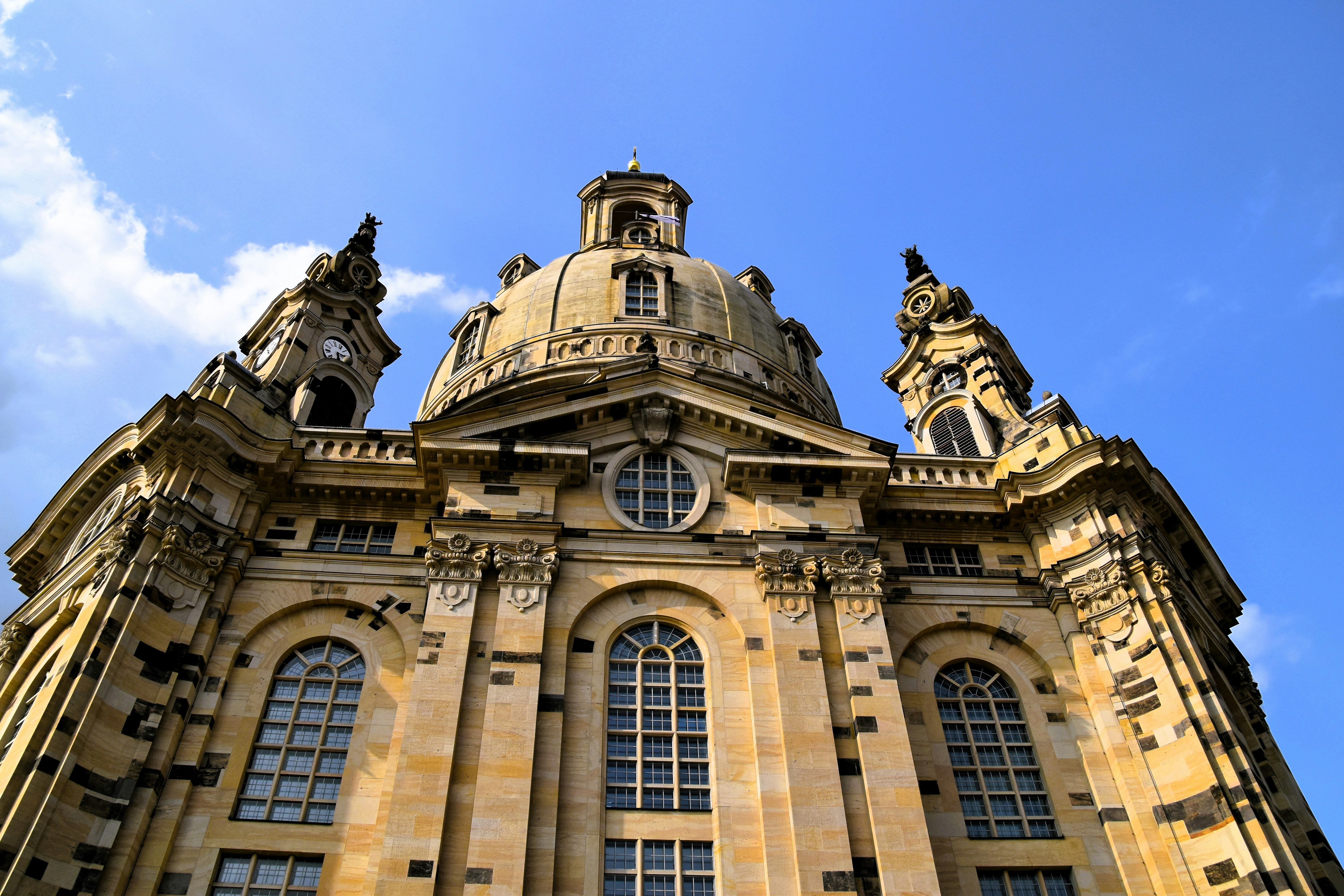 A grand, historic church towers against the blue sky.