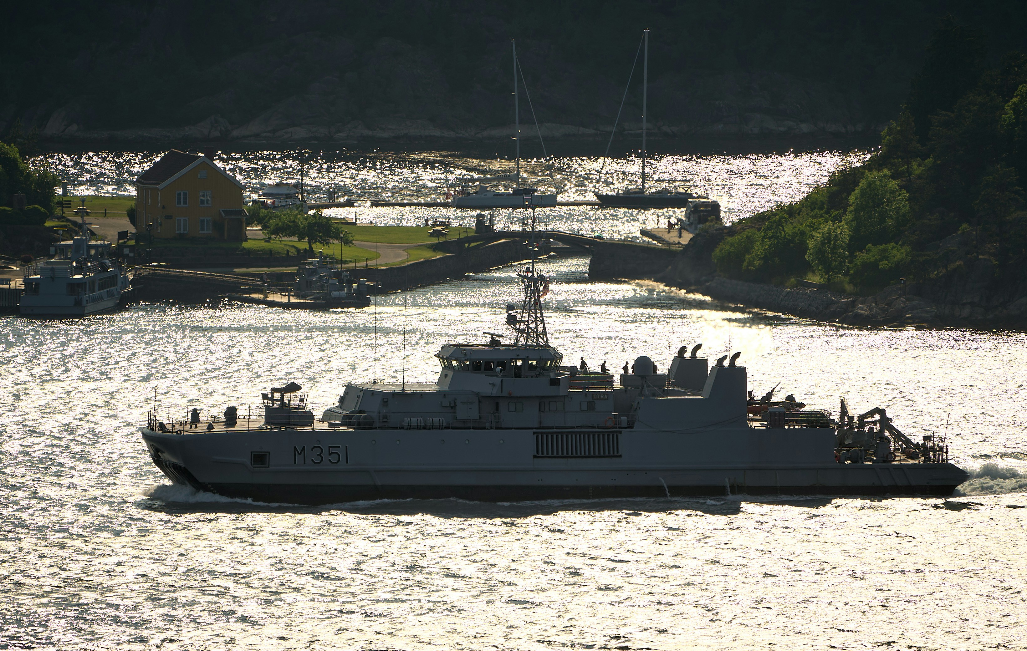 A military ship cruises through the water.