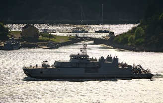 A military ship cruises through the water.