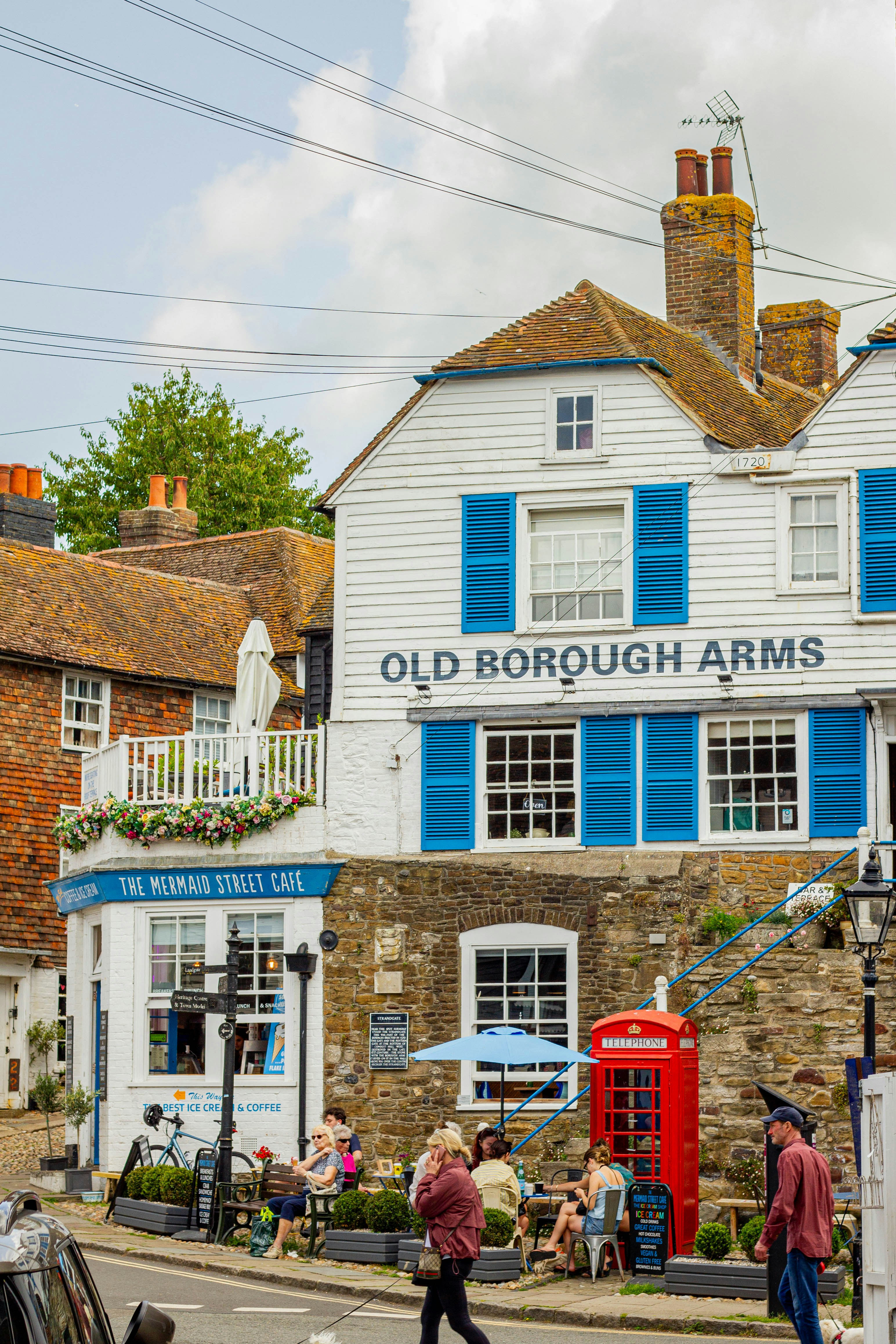 A charming pub and cafe with a red telephone booth.