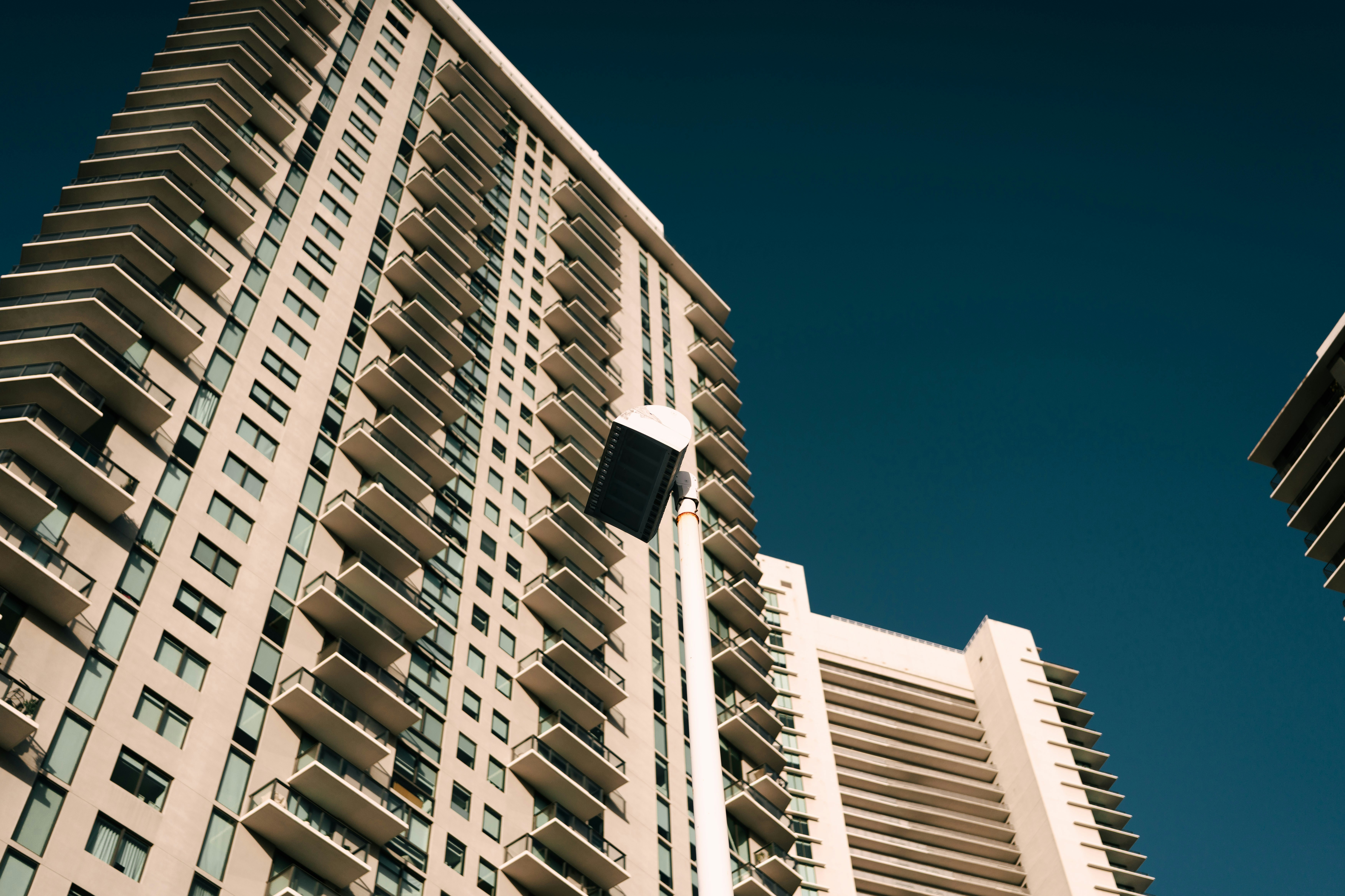 High-rise buildings are shown against a dark blue sky.