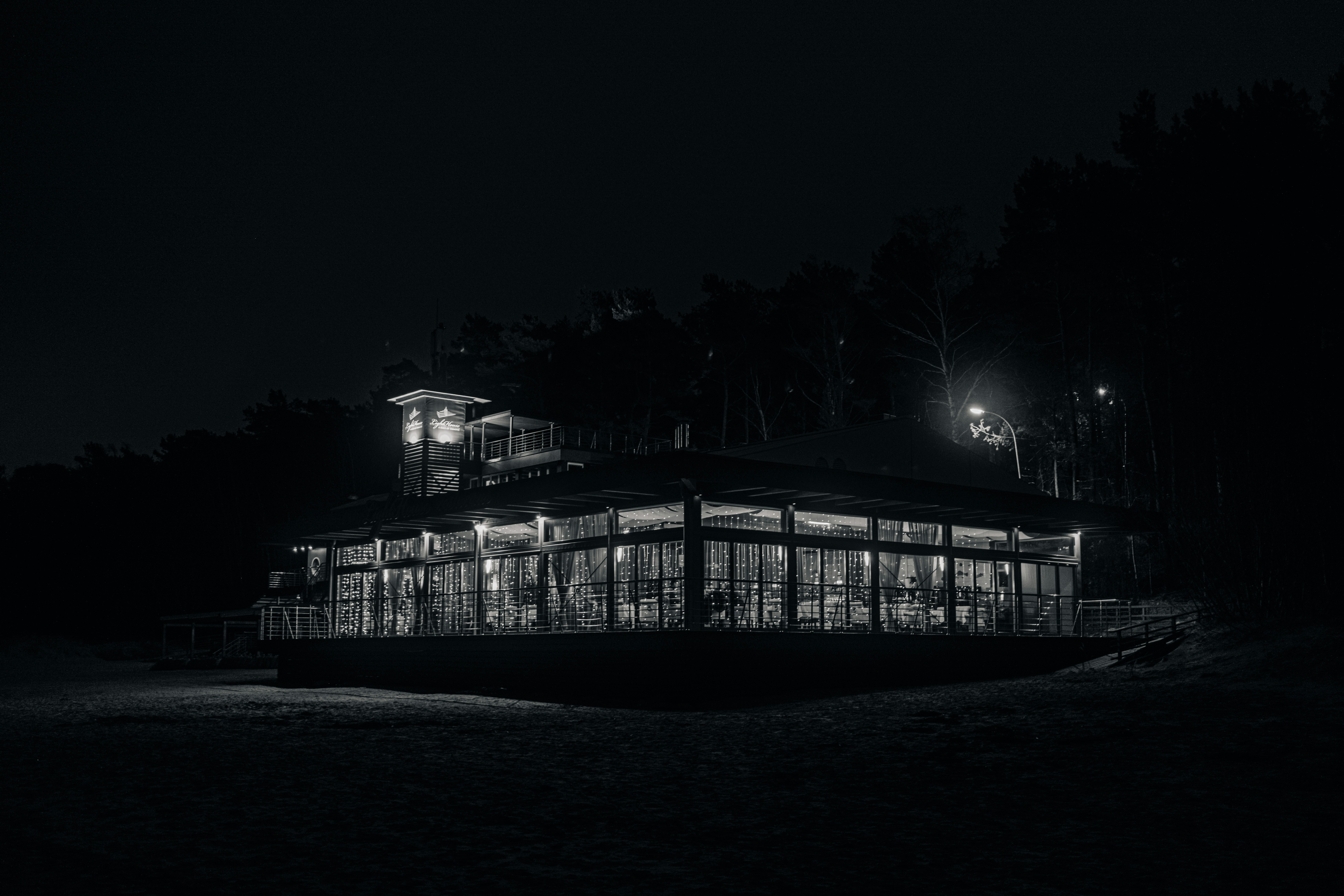 A house glows with lights at night.