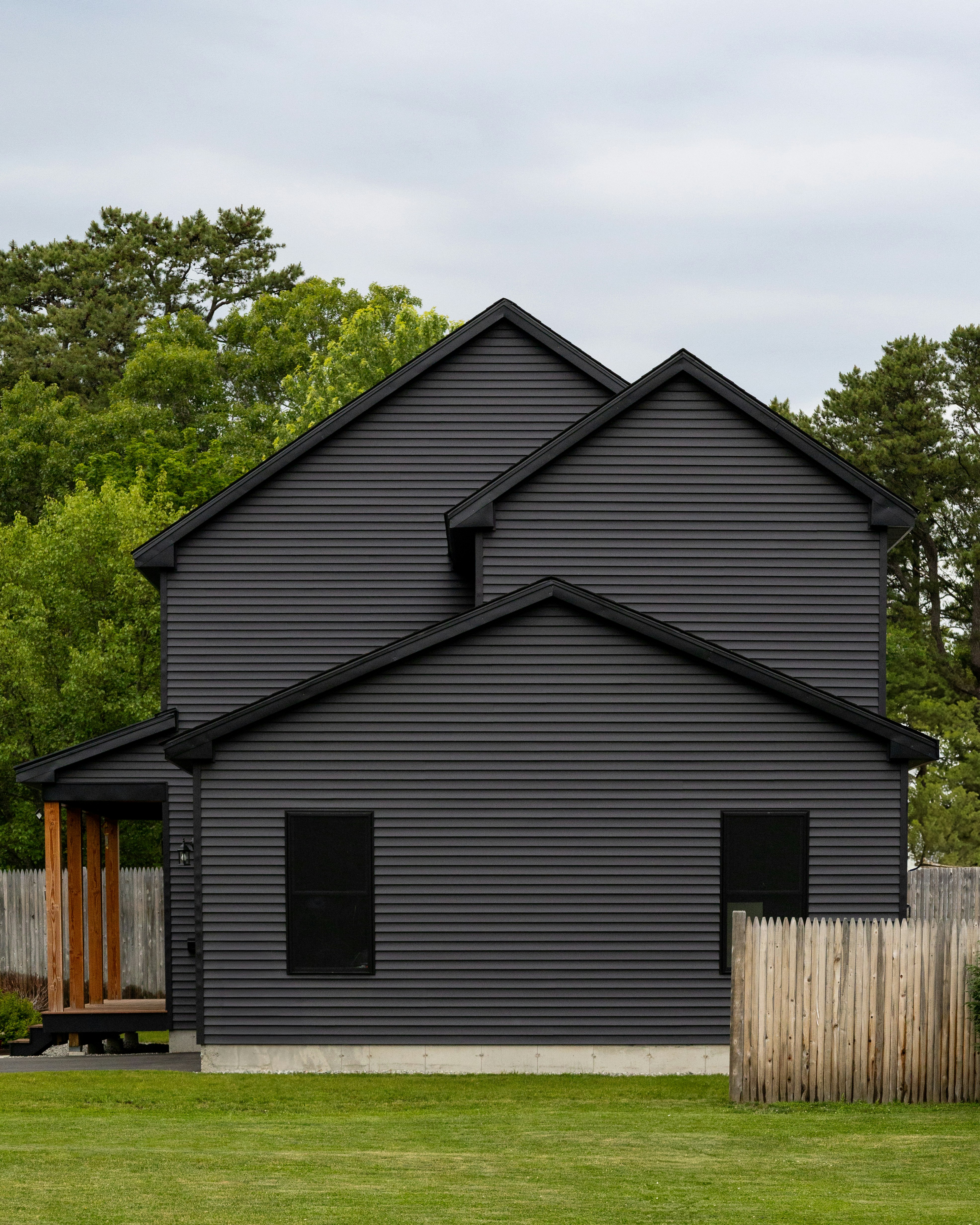 A modern home with dark gray siding.