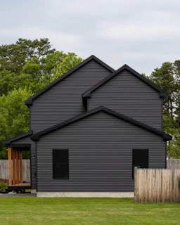 A modern home with dark gray siding.