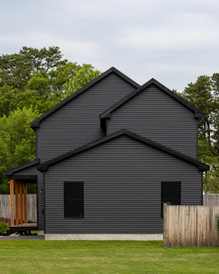 A modern home with dark gray siding.