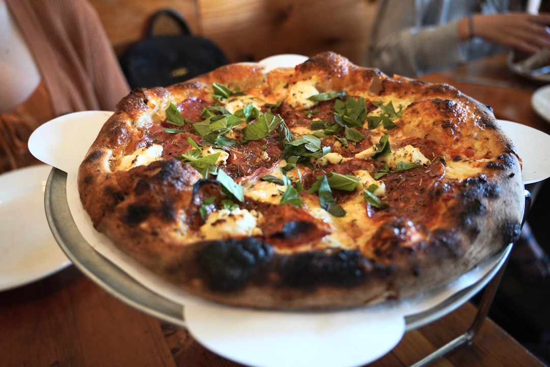 Here's a caption: fresh pizza, ready to be eaten.
