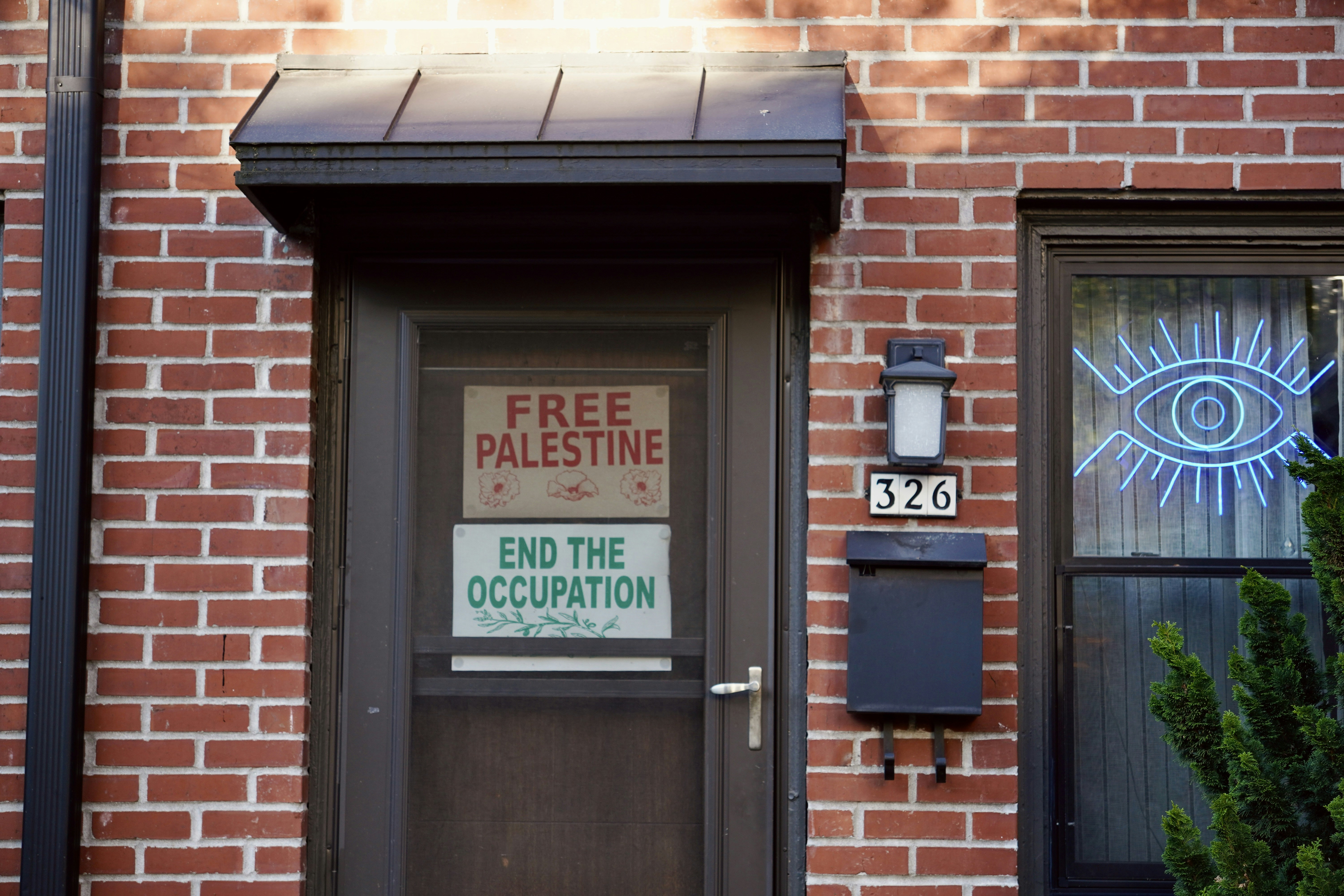 A residential front door in Newberg bears two signs: FREE PALESTINE and END THE OCCUPATION