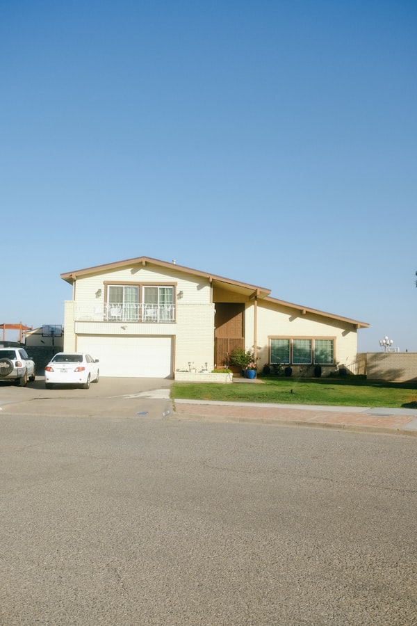 A suburban house exterior under a bright blue sky