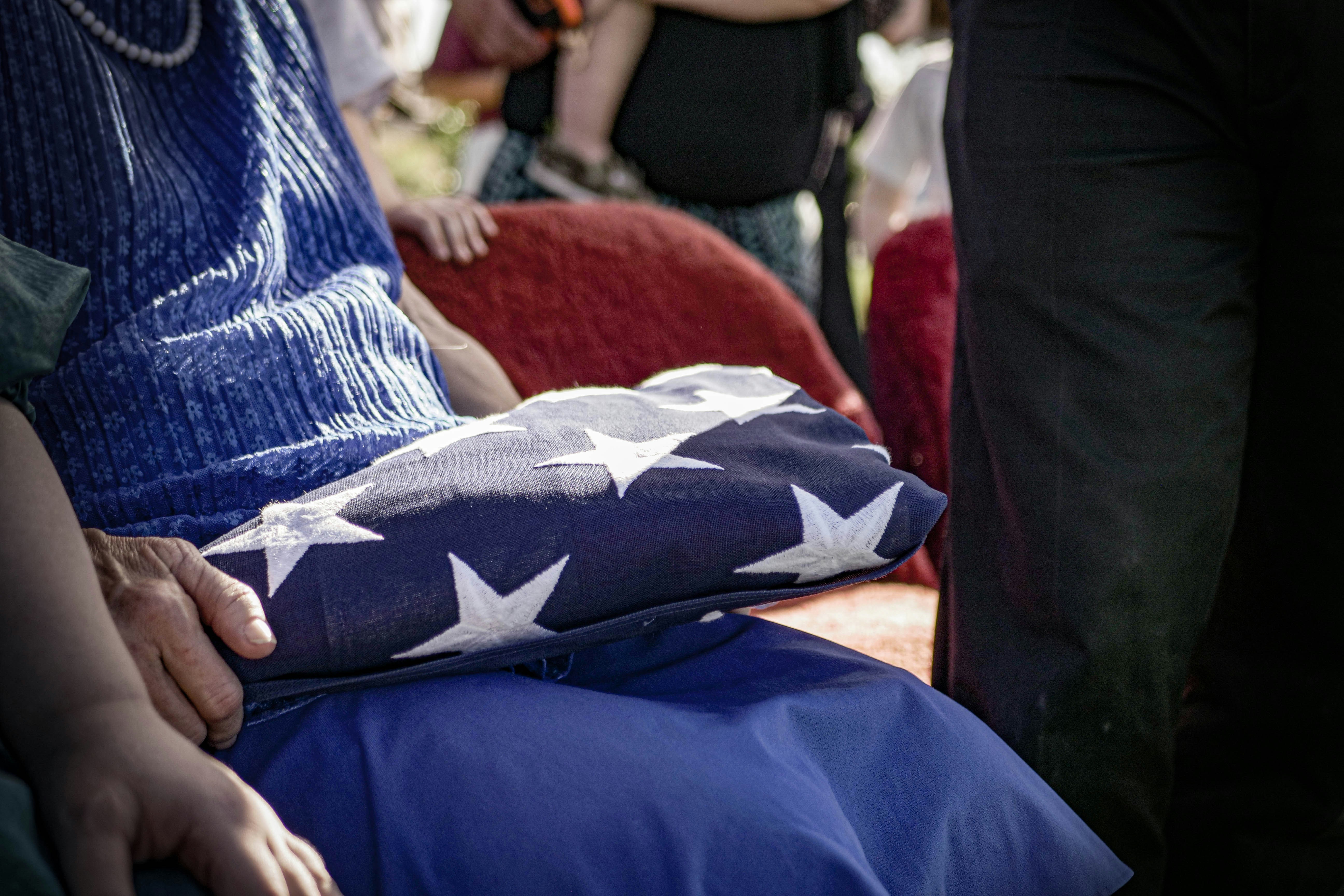 An american flag rests in someone's lap.