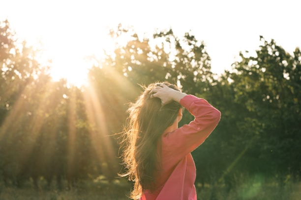 Woman enjoying sunlight in nature.