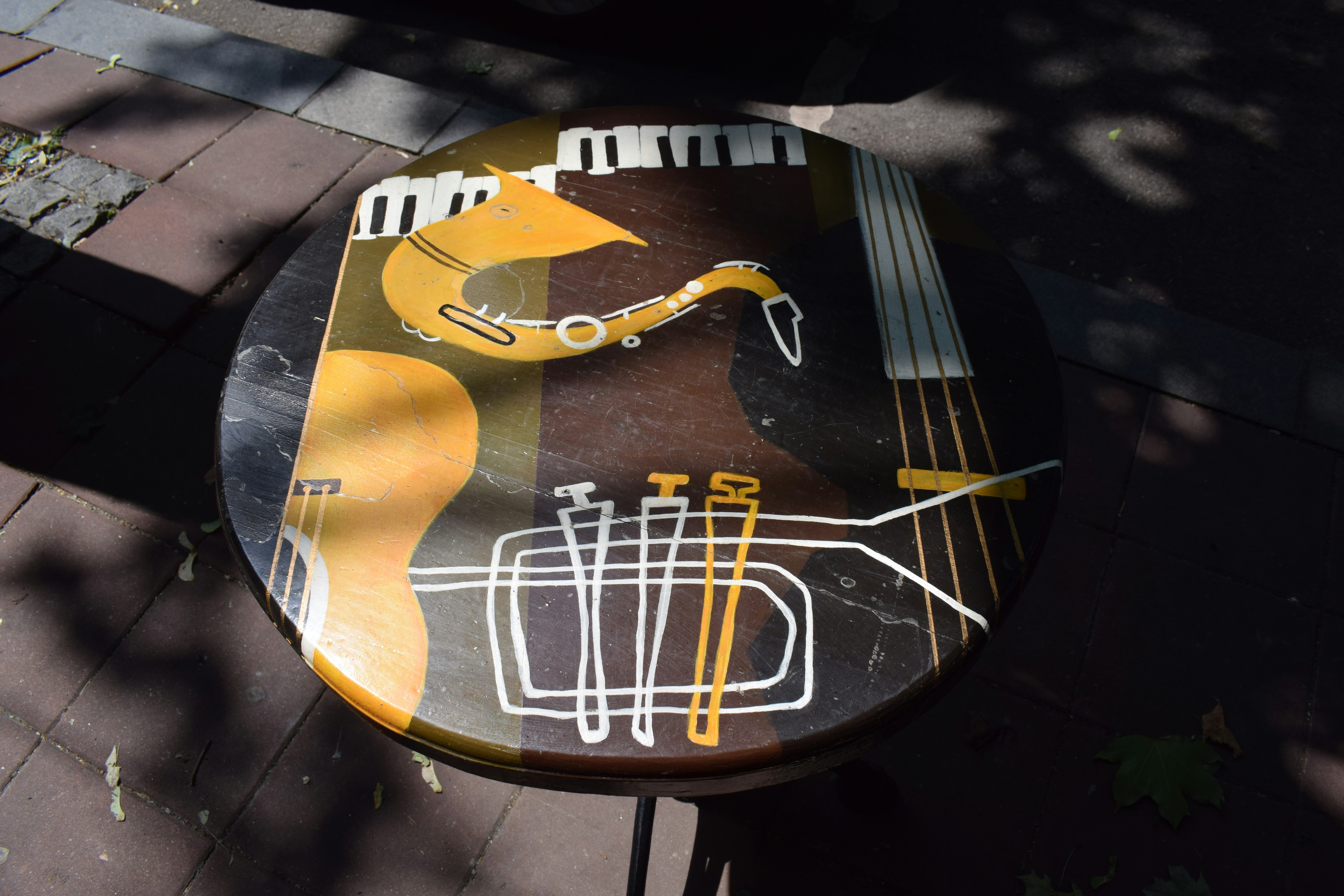 Musical instruments are depicted on a round, decorated table.