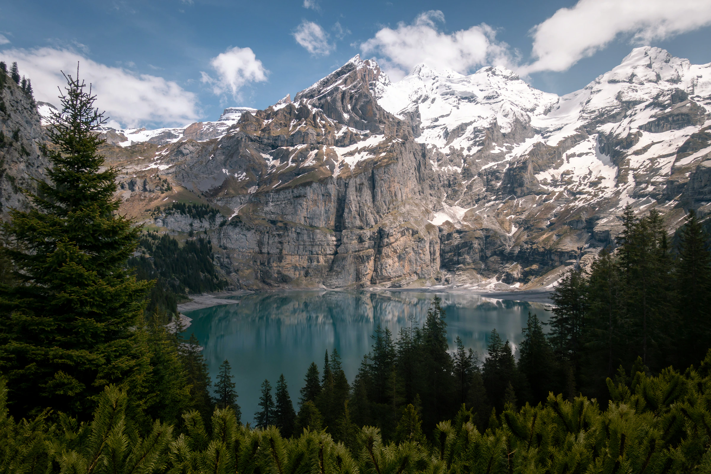Turquoise alpine lake surrounded by the majestic Swiss Alps