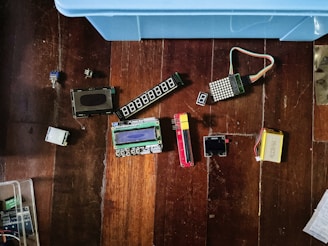 Electronic components are scattered on a wooden surface.