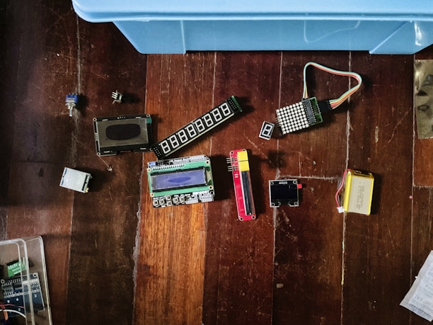 Electronic components are scattered on a wooden surface.