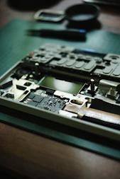 A laptop's disassembled internals on a workbench.