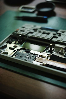 A laptop's disassembled internals on a workbench.