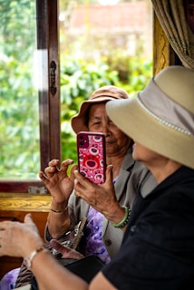 Two women on a train take a picture.