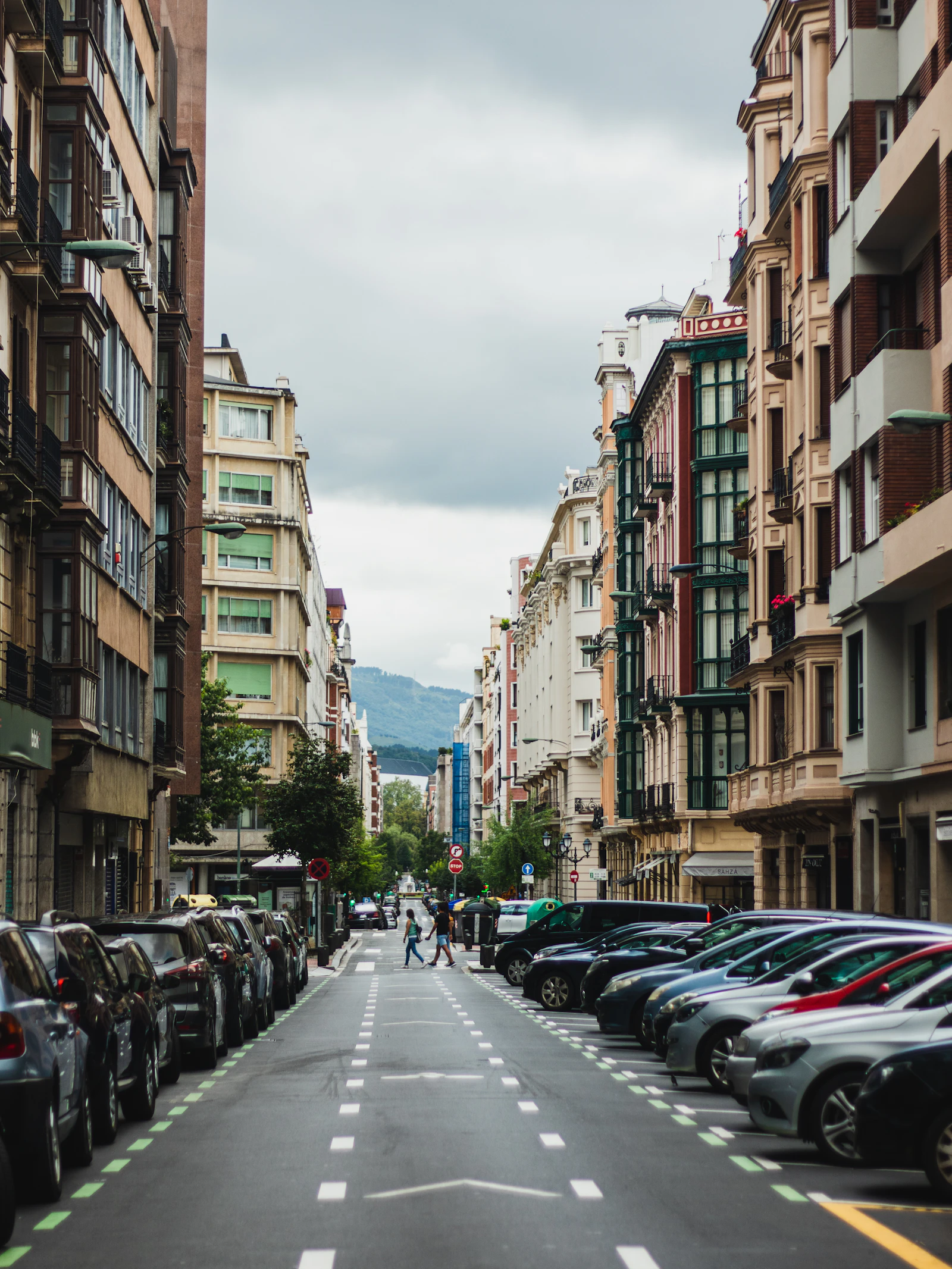 Bilbao street lined with apartments beneath surrounding hills