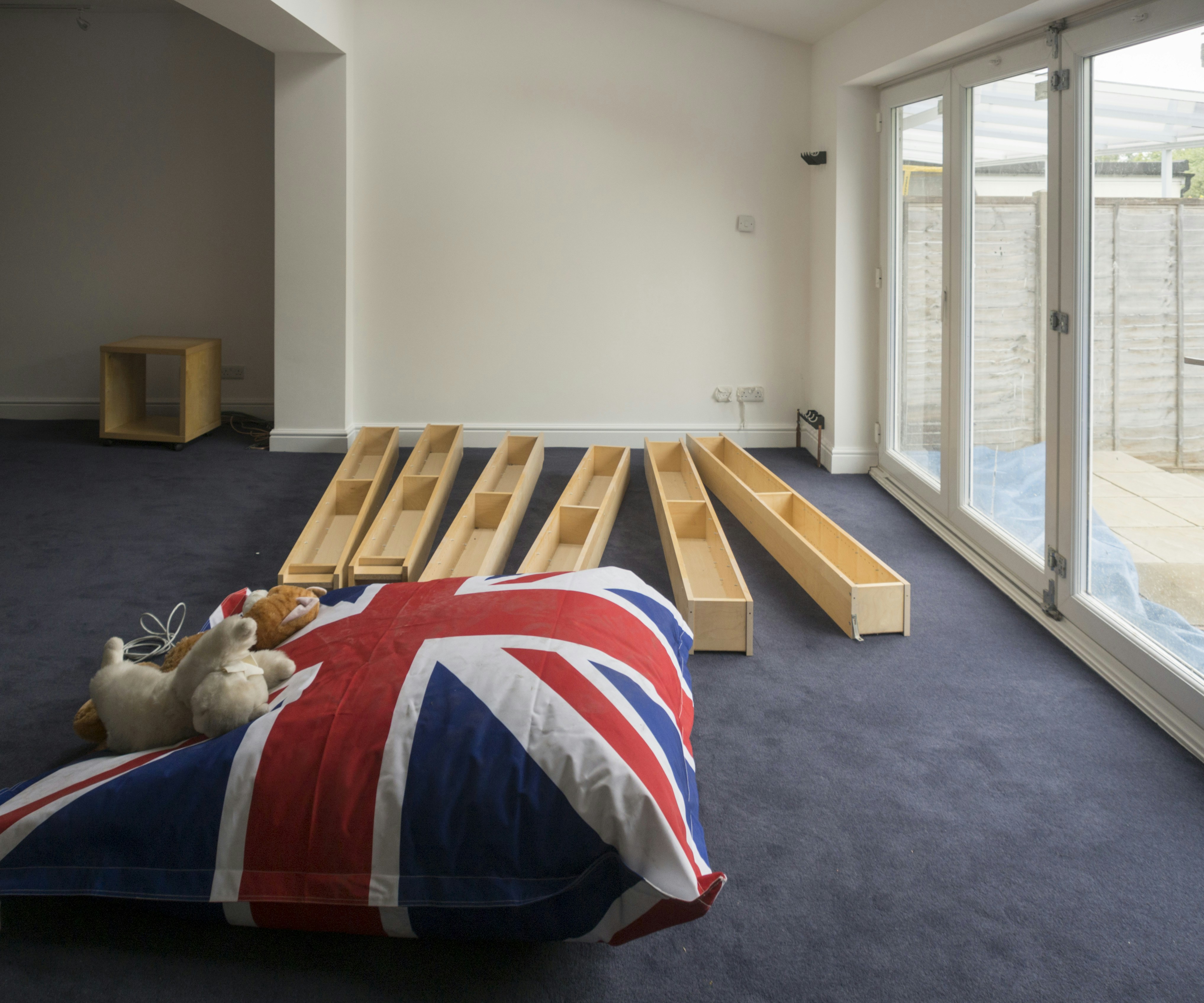 A room with a union jack beanbag and furniture.