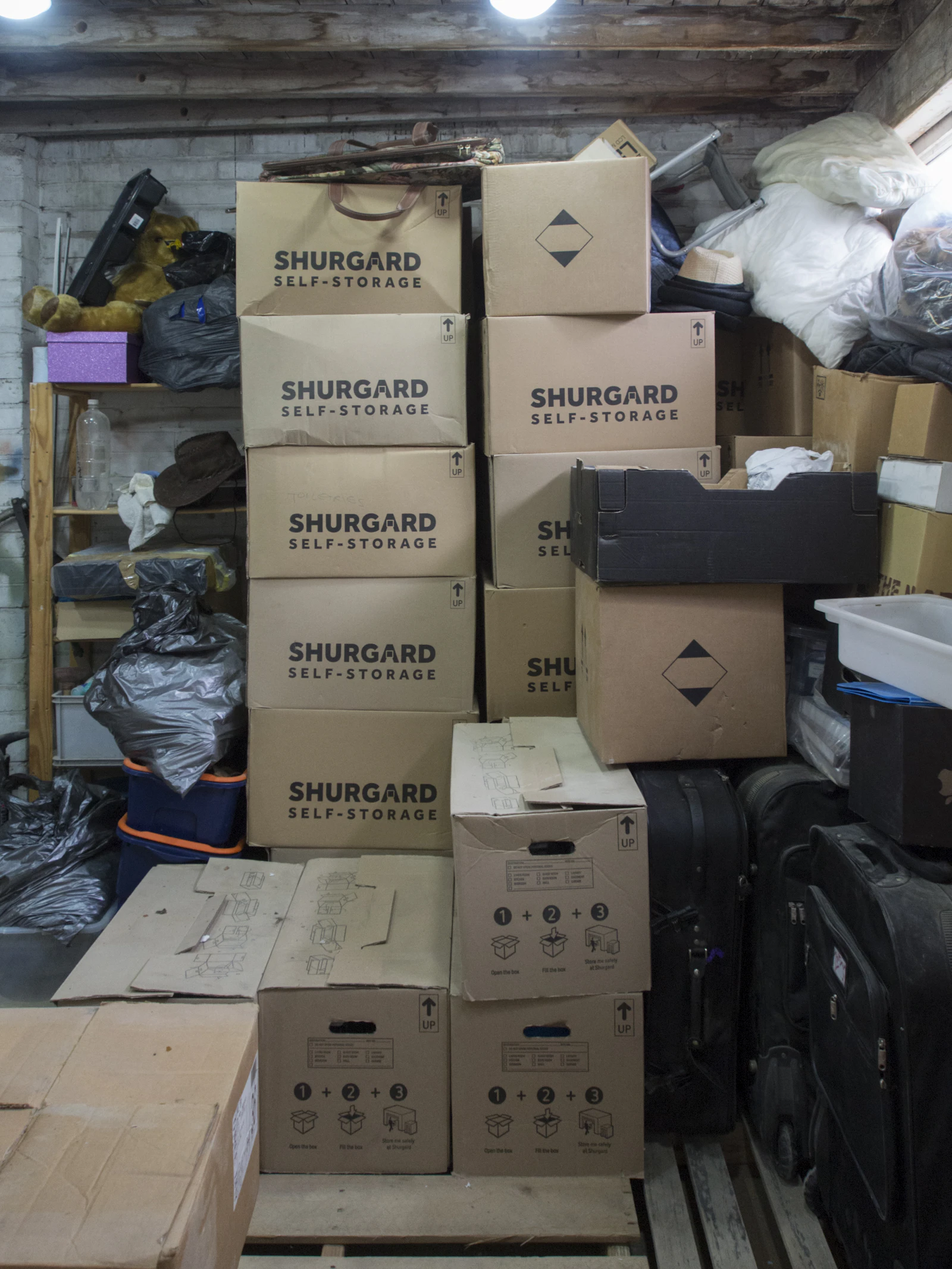 Boxes and household items grouped for sorting in a storage area