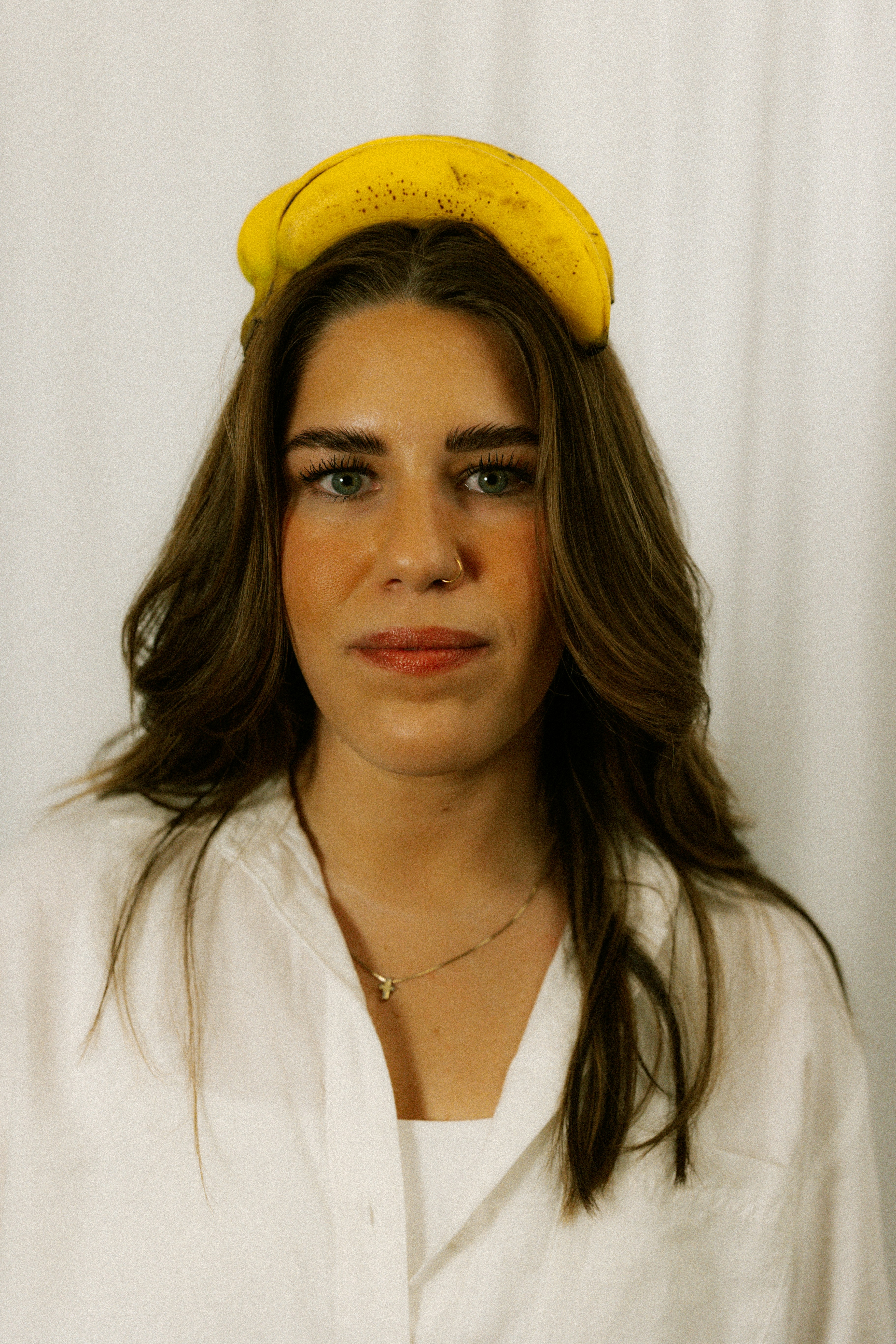 Woman is wearing a banana on her head.