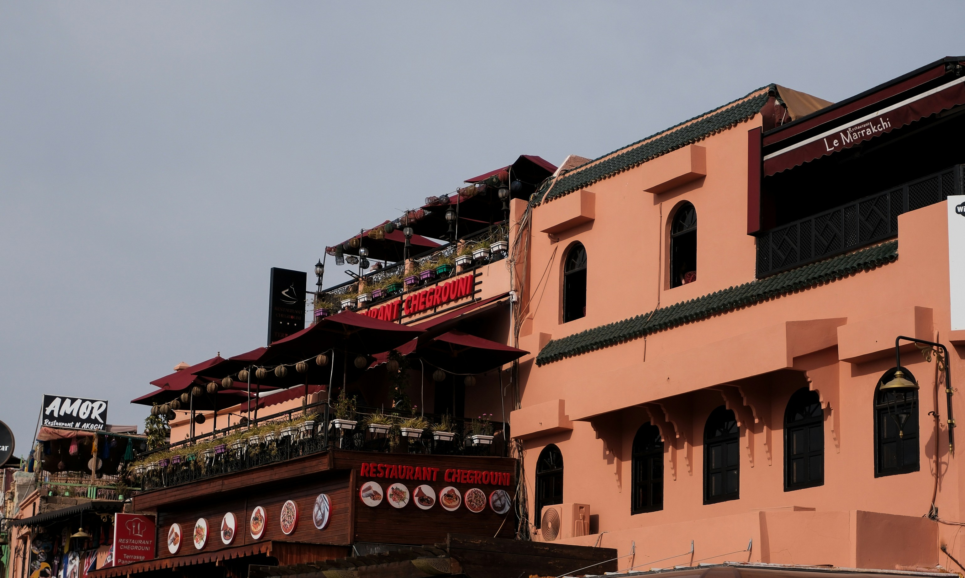 Buildings with red awnings and a clear sky.