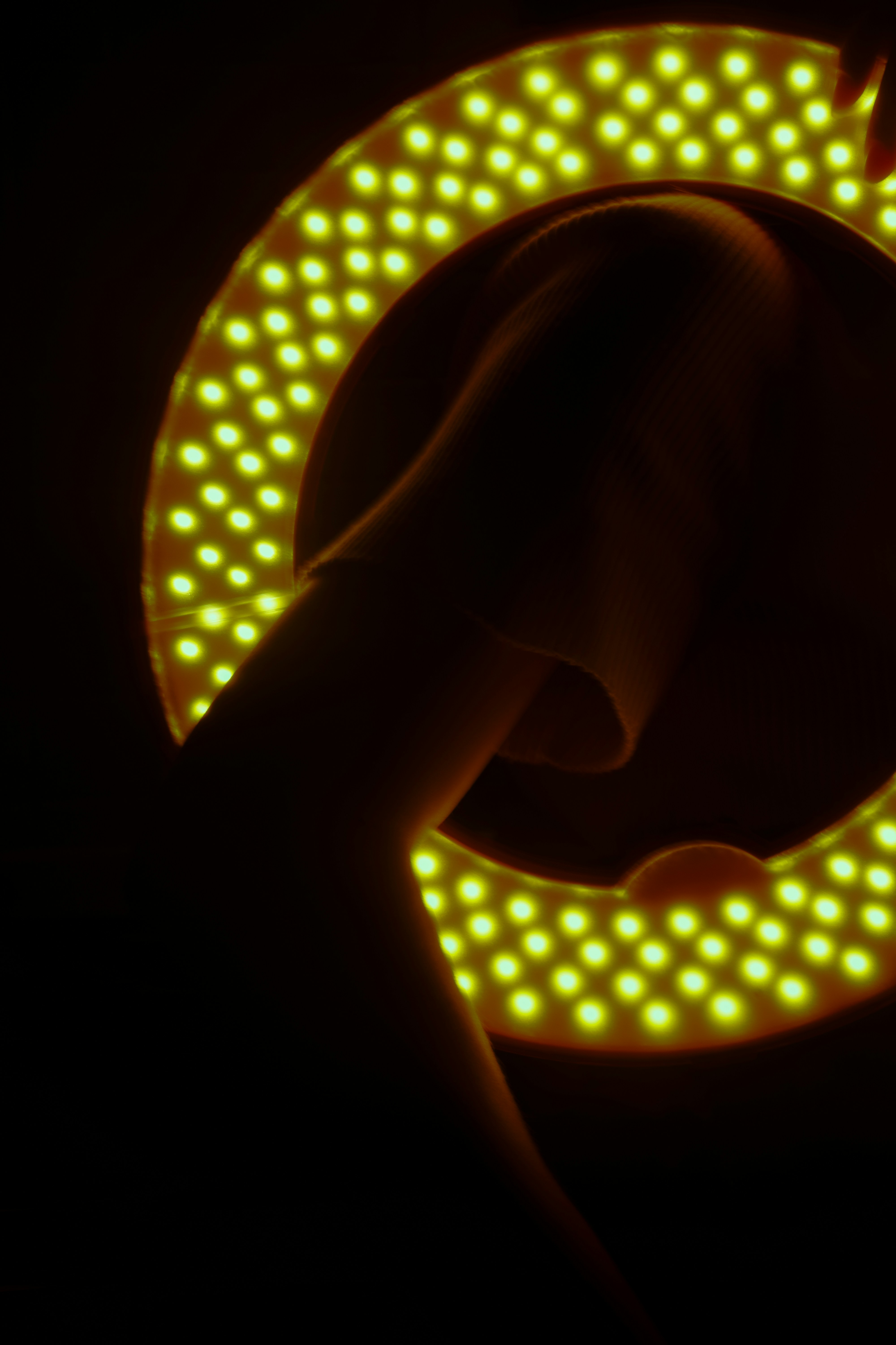 A glowing ring light circles around a person.