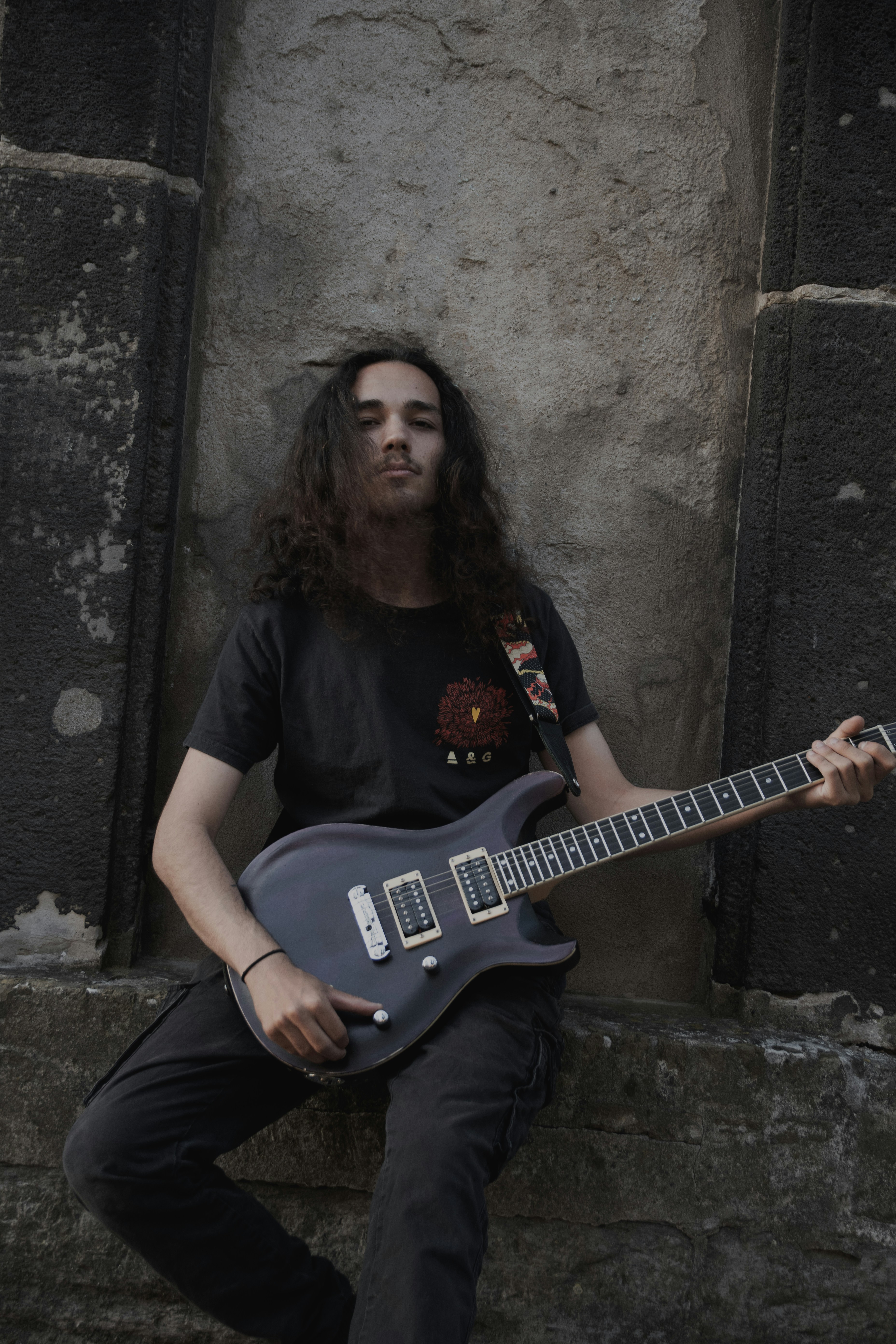 Guitarist poses with his instrument.