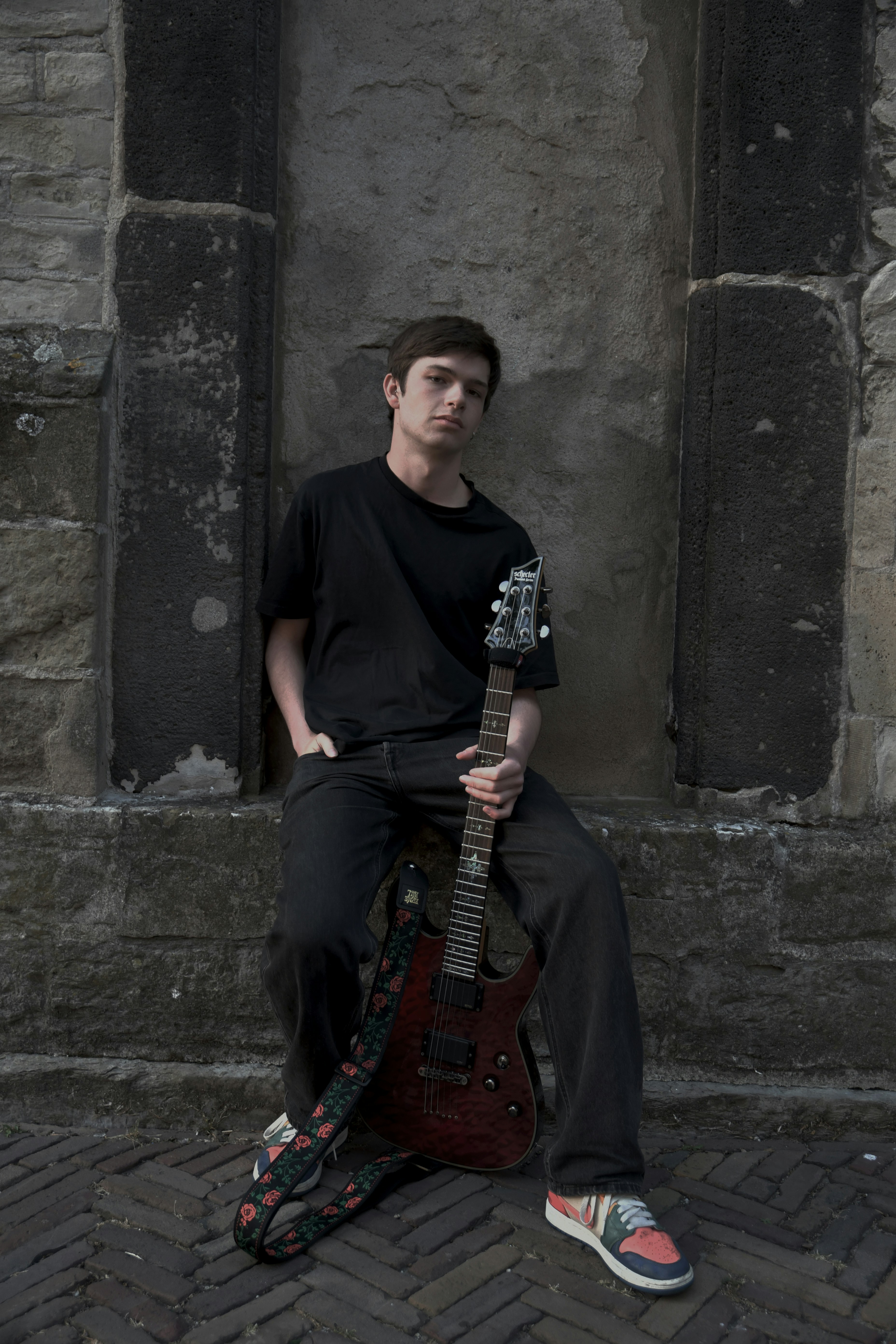 A man poses with his electric guitar.