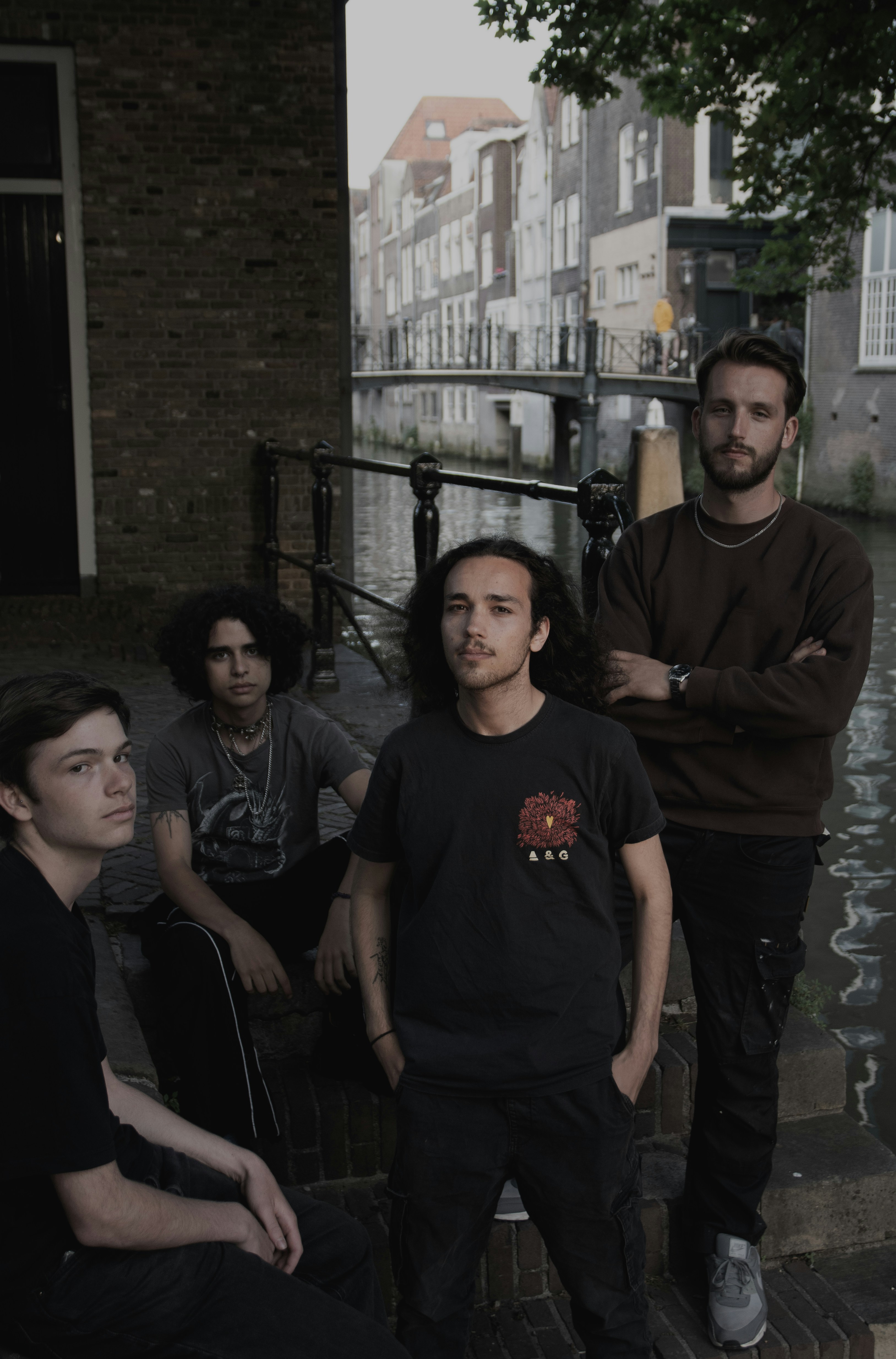 A band of young men poses by a canal.