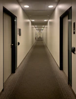 An empty hallway with doors stretches into the distance.