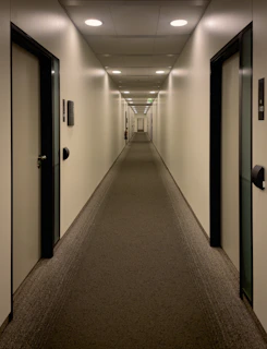 An empty hallway with doors stretches into the distance.