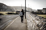 A person walks along a quiet road.