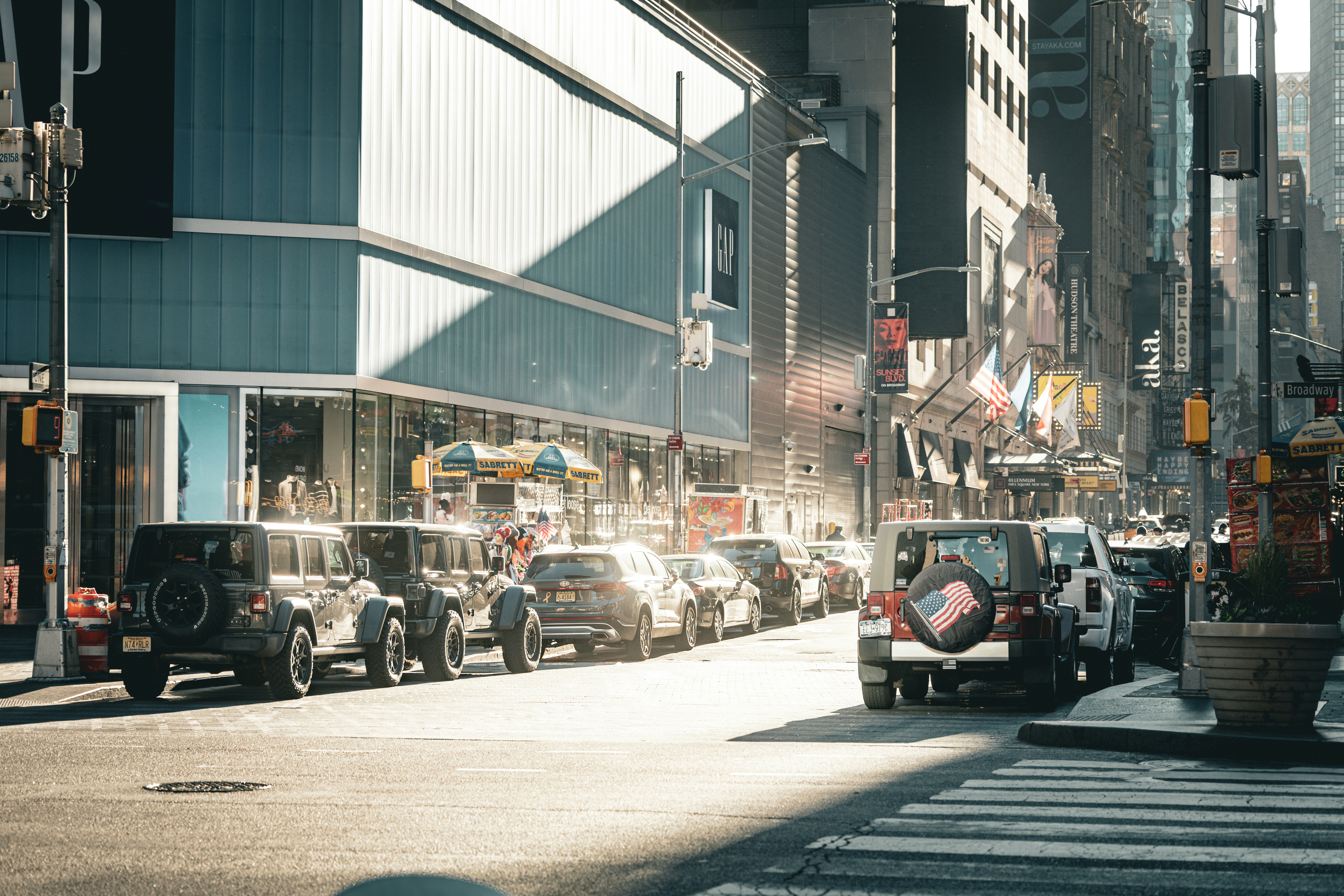 City street with parked cars and buildings.