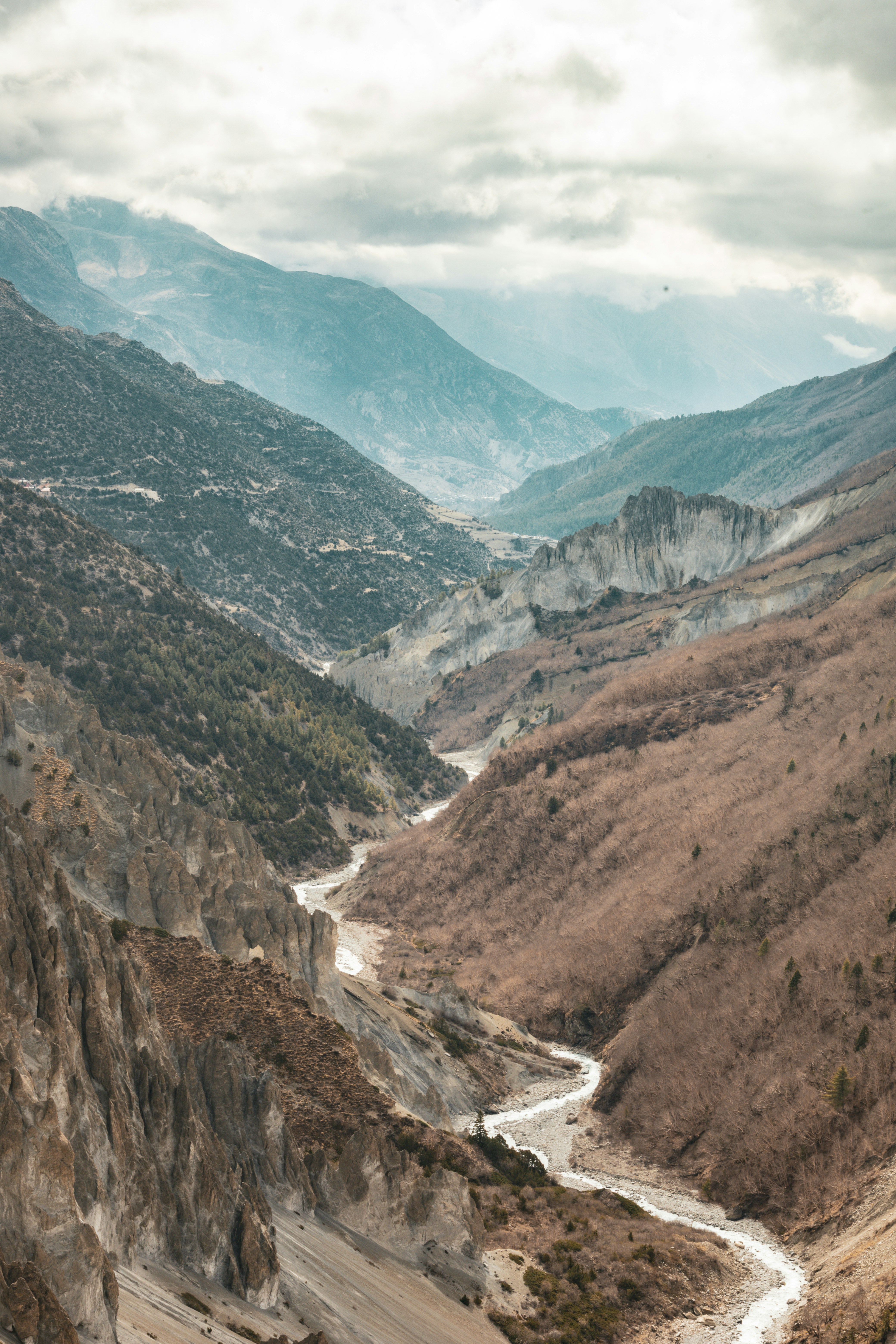 A winding river flows through a mountainous valley.