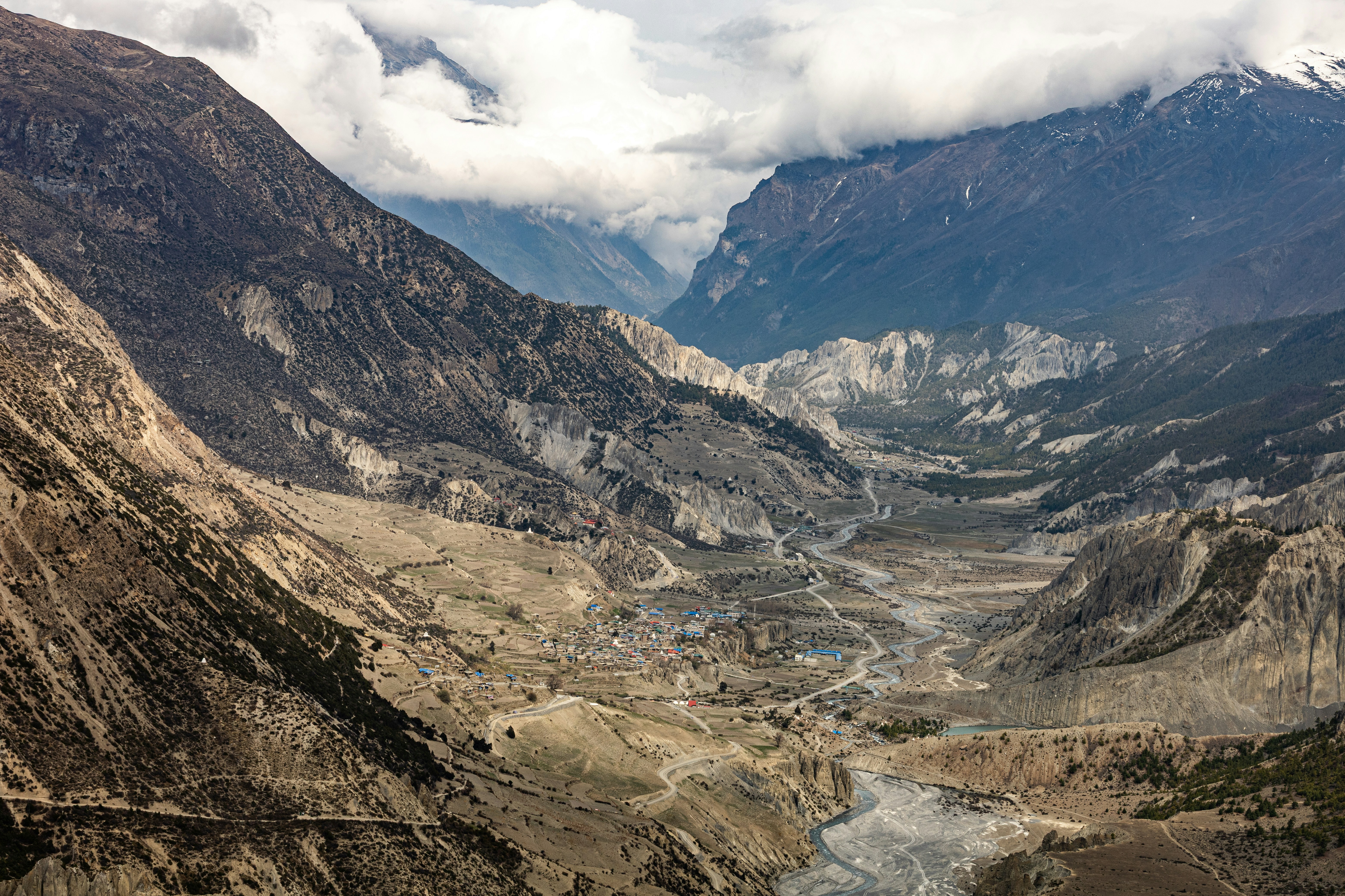 A scenic mountainous landscape with cloudy skies.