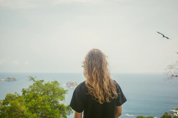 A person looks out over the ocean.