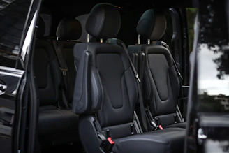 The inside of a black van reveals seats.