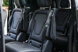 Luxurious black leather seats in a van.