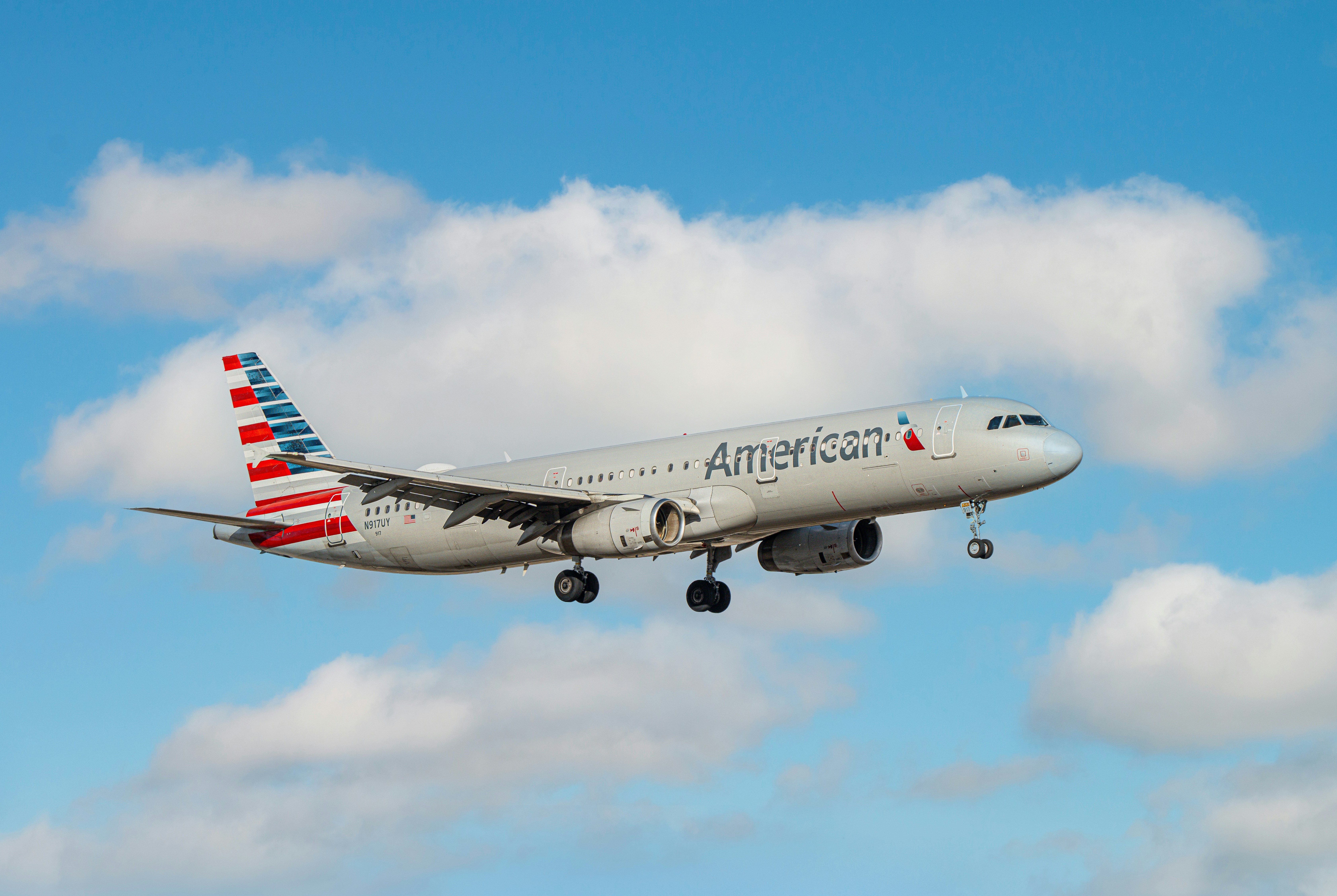 An american airlines airplane flies through the sky.